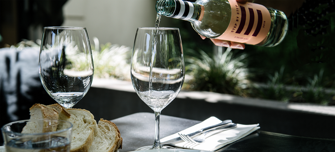 A person poruing Step by Step wine into a wine glass